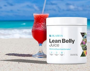 Lean Belly Juice container and red drink on a sandy beach with ocean in the background.