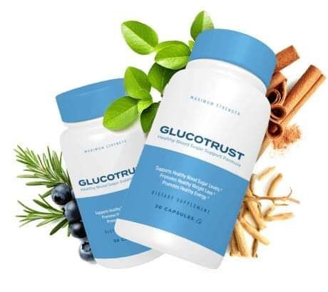 Two GlucoTrust supplement bottles surrounded by cinnamon sticks, blueberries, and green leaves.